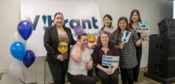 Vibrant Staff holding "Hope Happens Here" banners